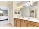 Double vanity bathroom with a view of a bedroom at 12261 Canavese Ln, Venice, FL 34293