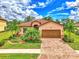 Single-story home with tile roof, landscaping and driveway at 12261 Canavese Ln, Venice, FL 34293