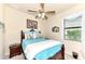 Bright bedroom with a teal comforter and wooden bed frame at 12261 Canavese Ln, Venice, FL 34293
