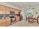 Modern kitchen featuring granite countertops and stainless steel appliances at 12261 Canavese Ln, Venice, FL 34293