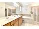 Elegant bathroom with double vanity, soaking tub, and walk-in shower at 12261 Canavese Ln, Venice, FL 34293