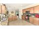 Open concept kitchen with granite countertops and stainless steel appliances at 12261 Canavese Ln, Venice, FL 34293
