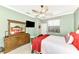 Spacious bedroom with a wooden dresser and large TV at 12261 Canavese Ln, Venice, FL 34293