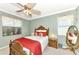 Charming bedroom with a wooden bed frame and red accents at 12261 Canavese Ln, Venice, FL 34293