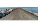 Long jetty with rocks on either side leading to ocean at 351 Woodvale Dr, Venice, FL 34293