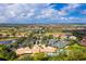 Aerial view of community clubhouse, pool, and tennis courts at 122 Tiziano Way, North Venice, FL 34275