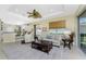 Living room with open kitchen and island, neutral decor, and a view to the backyard at 122 Tiziano Way, North Venice, FL 34275