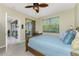 Bedroom with a queen bed, access to a private patio, and lots of natural light at 122 Tiziano Way, North Venice, FL 34275