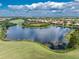 Aerial view of a lake surrounded by houses at 122 Tiziano Way, North Venice, FL 34275