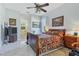 Spacious bedroom with a large bed, dresser, and ensuite bathroom access at 12004 Sarto Ln, North Port, FL 34287