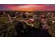 Aerial view of a house on the water at sunset at 12004 Sarto Ln, North Port, FL 34287