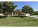 House exterior with lush landscaping and a paved driveway at 12004 Sarto Ln, North Port, FL 34287