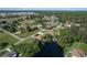 An aerial view showcasing a neighborhood with houses and a lake at 12004 Sarto Ln, North Port, FL 34287