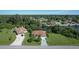 Two houses with driveways and garages near a canal at 12004 Sarto Ln, North Port, FL 34287