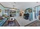Spacious living room with teal couches and access to a patio at 12004 Sarto Ln, North Port, FL 34287