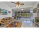 Relaxing sunroom with wicker furniture and view of backyard at 12004 Sarto Ln, North Port, FL 34287