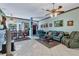 Spacious living room with teal couches, dining area, and tiled floors at 12004 Sarto Ln, North Port, FL 34287