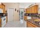 Kitchen features wood cabinets, granite countertops, and white appliances at 12004 Sarto Ln, North Port, FL 34287