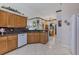 Kitchen with granite countertops, wood cabinets, and a dishwasher at 12004 Sarto Ln, North Port, FL 34287