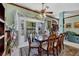 Formal dining room with wood table and chairs, and large windows at 12004 Sarto Ln, North Port, FL 34287
