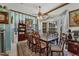 Formal dining room with wood table and chairs, and large windows at 12004 Sarto Ln, North Port, FL 34287