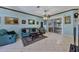 Living room with teal couches, and view of the dining area at 12004 Sarto Ln, North Port, FL 34287