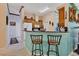 Bright kitchen with wood cabinets, granite counters, and breakfast bar at 12004 Sarto Ln, North Port, FL 34287