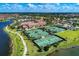 Community overview with tennis courts and lake at 19866 Benissimo Dr, Venice, FL 34293