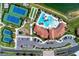 Overhead view of community amenities featuring tennis courts and swimming pool with lush landscaping at 12000 Tapestry Ln, Venice, FL 34293