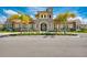 Beautiful clubhouse featuring stone accents, a tile roof, and lush landscaping in a vibrant community at 12000 Tapestry Ln, Venice, FL 34293