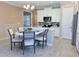 Kitchen with a center island, white cabinets, stainless steel appliances, and breakfast nook at 12000 Tapestry Ln, Venice, FL 34293