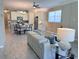 Open living space with kitchen, dining area, and living room, featuring wood-look tile and bright ambiance at 12000 Tapestry Ln, Venice, FL 34293
