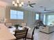 An open concept view of the kitchen and living spaces, complete with fans, bright decor and lots of light at 12000 Tapestry Ln, Venice, FL 34293