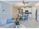 Open concept living room and kitchen featuring stylish decor and an abundance of natural light at 12000 Tapestry Ln, Venice, FL 34293