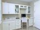 Home office featuring built-in cabinetry with glass inserts, a desk, and natural light at 12000 Tapestry Ln, Venice, FL 34293