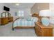 Spacious bedroom with wood furniture and a large bed at 2183 Nettlebush Ln, Venice, FL 34292