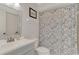 Clean bathroom with modern vanity, toilet, and patterned shower curtain at 5103 Greencroft Rd, Sarasota, FL 34235