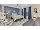 Cozy bedroom with blue accent wall, ceiling fan, and natural light at 5103 Greencroft Rd, Sarasota, FL 34235