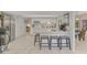 Bright, open kitchen with white cabinets, stainless steel appliances, and breakfast bar at 5103 Greencroft Rd, Sarasota, FL 34235