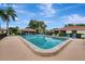 Community pool featuring lounge chairs, palm trees and well maintained grounds at 5103 Greencroft Rd, Sarasota, FL 34235