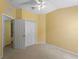 Bright bedroom with ceiling fan and double door closet at 5217 Layton Dr, Venice, FL 34293