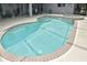 Large kidney shaped pool with attached spa at 4241 Chamrade Rd, North Port, FL 34288