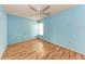 Bedroom with light blue walls and wood flooring at 4283 Eastwood Dr, Sarasota, FL 34232