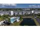 Aerial view of the community featuring a pool, pond, and parking at 1401 S Mccall Rd # 107B, Englewood, FL 34223