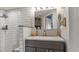 Modern bathroom with gray vanity, white subway tile shower, and built-in shelving at 1401 S Mccall Rd # 107B, Englewood, FL 34223