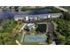 Aerial view of the community, tennis court, pool, and pond at 1401 S Mccall Rd # 107B, Englewood, FL 34223