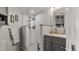 Modern bathroom with gray vanity, white subway tile shower, and built-in shelving at 1401 S Mccall Rd # 107B, Englewood, FL 34223