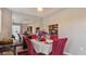 Charming dining area with red chairs and a view of the kitchen at 1401 S Mccall Rd # 107B, Englewood, FL 34223