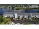 Aerial view of condo building with parking and waterfront access at 1401 S Mccall Rd # 107B, Englewood, FL 34223