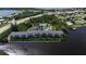 Aerial view of waterfront condo building with pool and boat docks at 1401 S Mccall Rd # 107B, Englewood, FL 34223